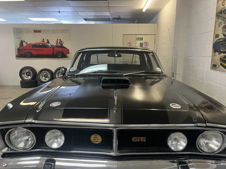 Front of a black Ford Falcon XY GT with bonnet scoop, quad headlights and 351 GT V8 grille badge